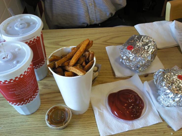 several cups of drinks and food on a table