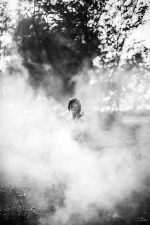 a black and white pograph of a woman in the mist