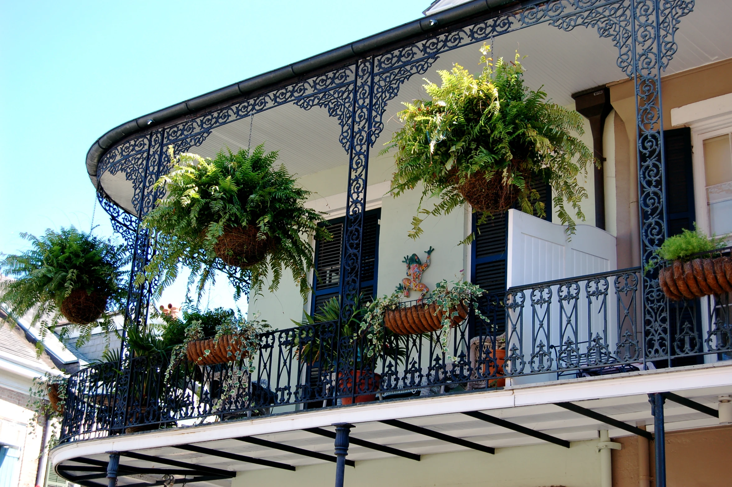 a balcony with planters hanging on it's balconies