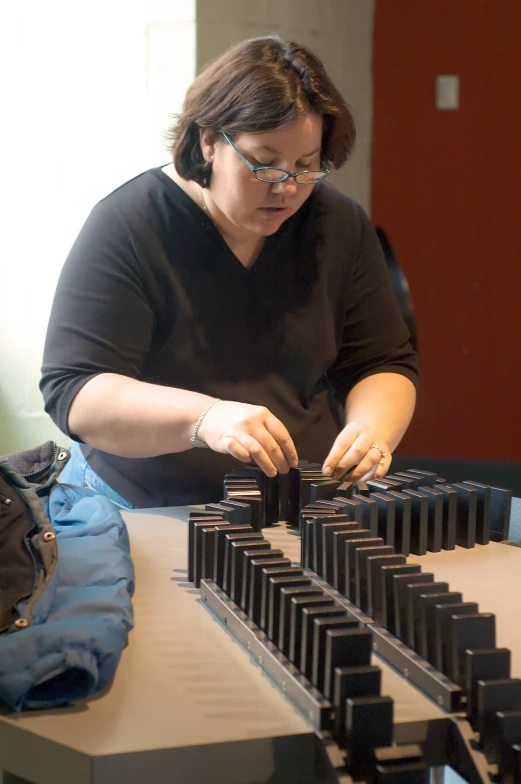 the woman is holding the long piece of metal on the counter