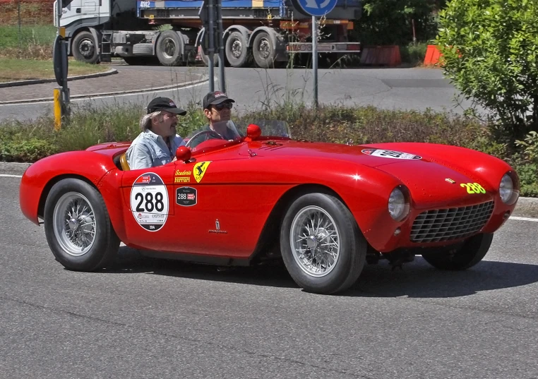 a man is driving a vintage race car