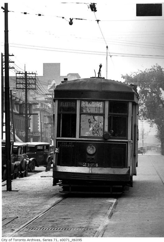 the trolley is traveling down the street in the black and white po