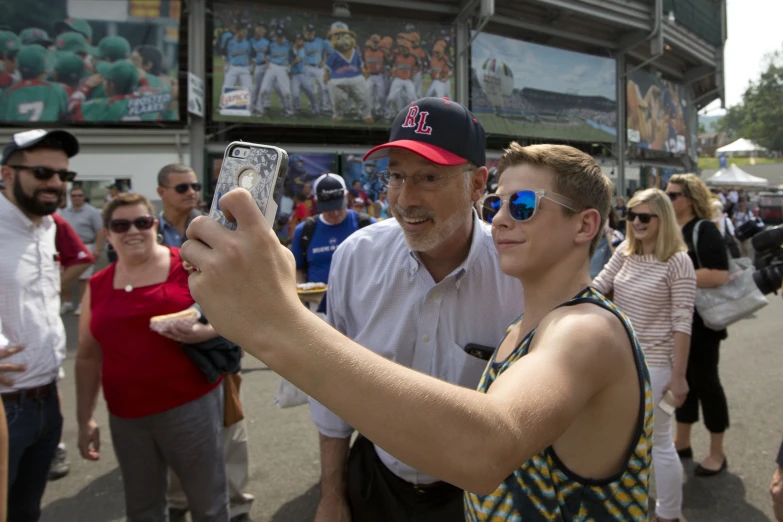 a man and woman take pictures with their cellphones