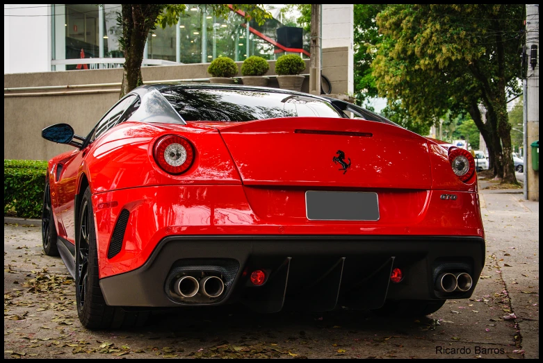 red car parked in front of a building on the street