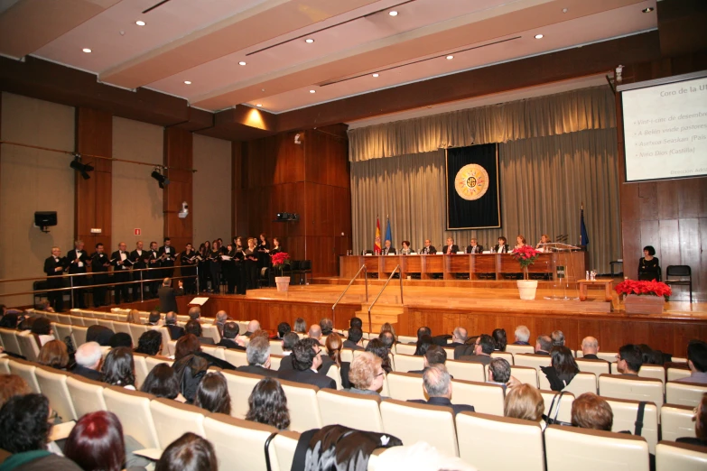 a group of people sitting at a meeting