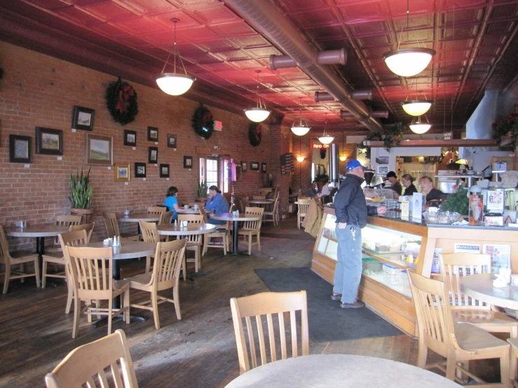 people are sitting at tables at a restaurant