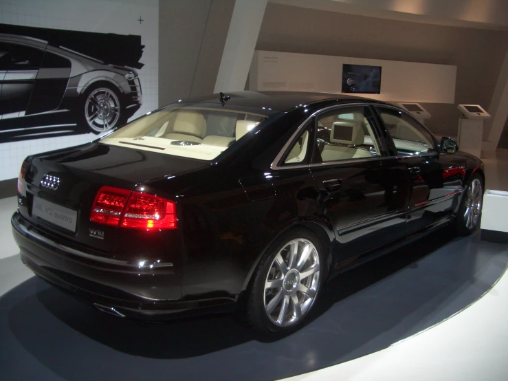 an audi in a showroom with its hood open