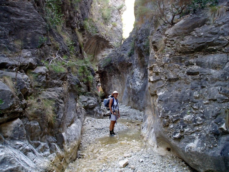 a person is hiking through the narrows of a river