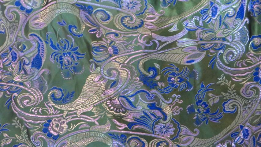 the close up view of an ornate blue and gold background