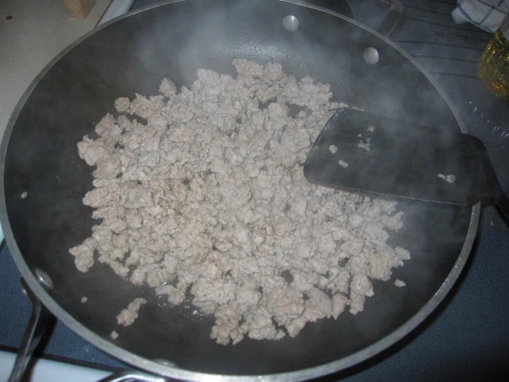 a large pan containing dry food on the stove