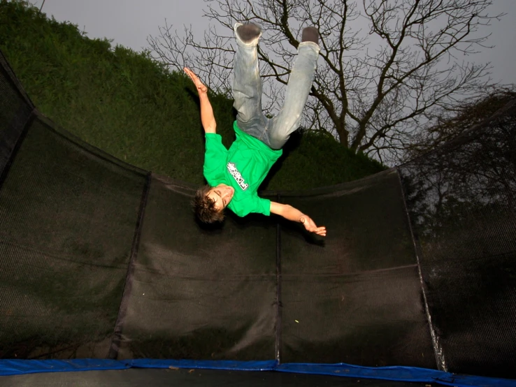 a man on a trampoline in the middle of the air
