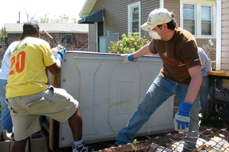 three men working on a new white fence