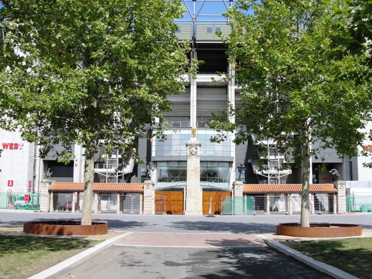 a park with benches and trees in front of a building