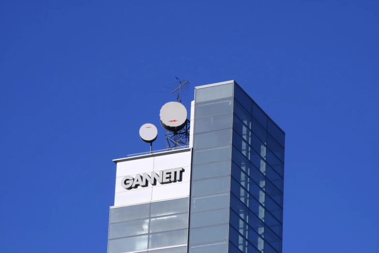 two satellite dishes on top of an office building