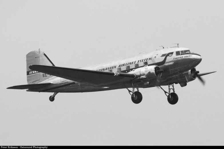 a black and white po of a vintage propeller airplane