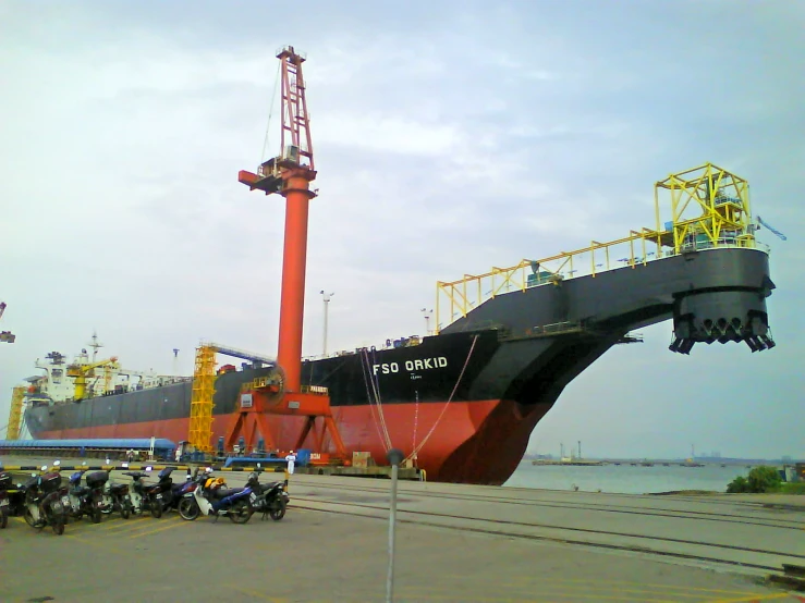 a large cargo ship sits docked in the port