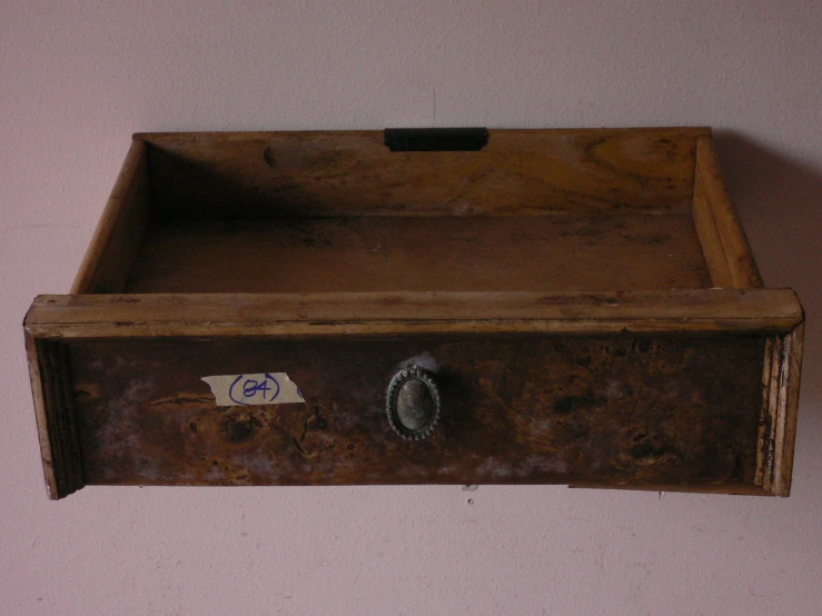 a wooden storage box on a pink wall