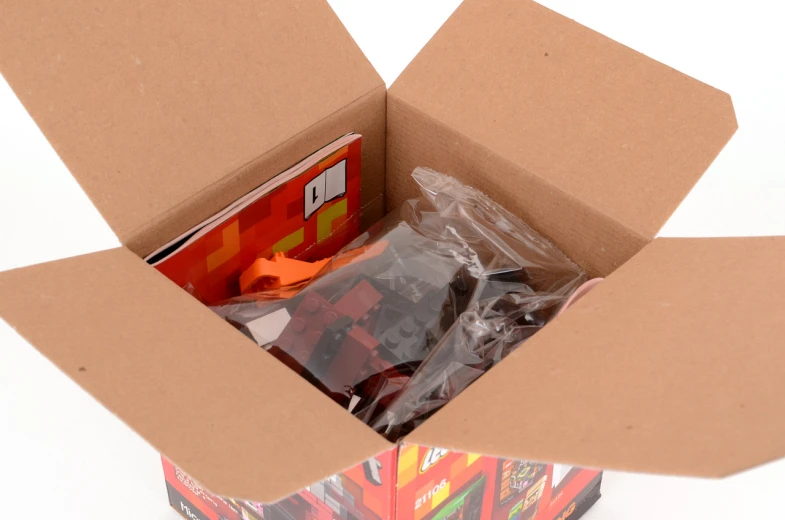 an open cardboard box with plastic toys in it