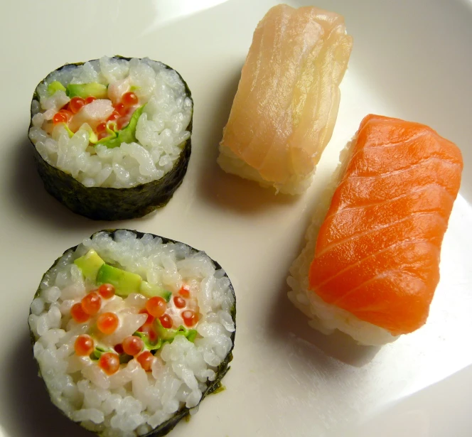 three sushi on the plate with different ingredients