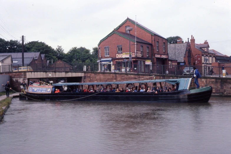 a big boat with people on it floating down a river