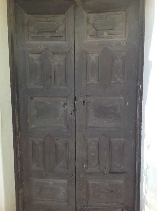 an old wooden door with several compartments