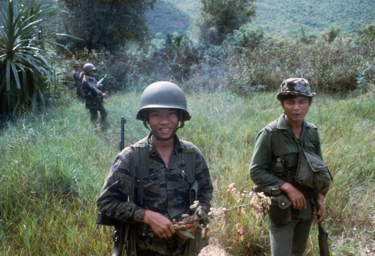 soldiers stand on a path with guns