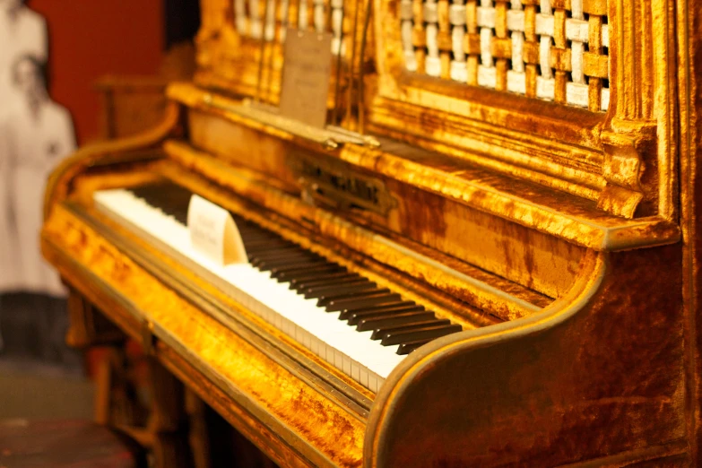 the small, gold - plated piano is the focal point for this s