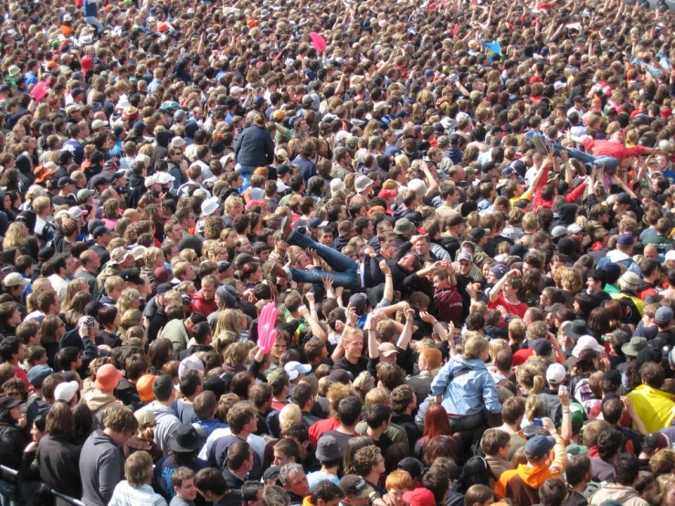 a large group of people are standing in a field