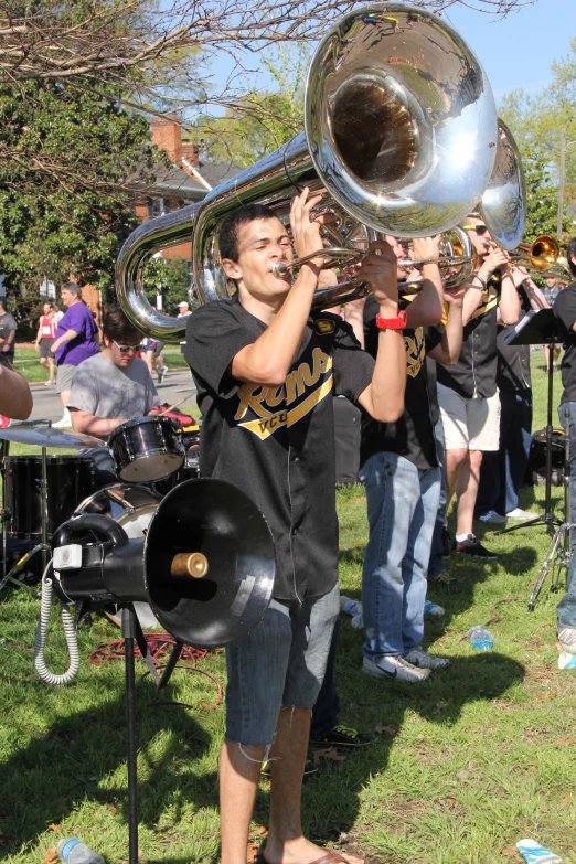 there is a band playing a trombone in the grass