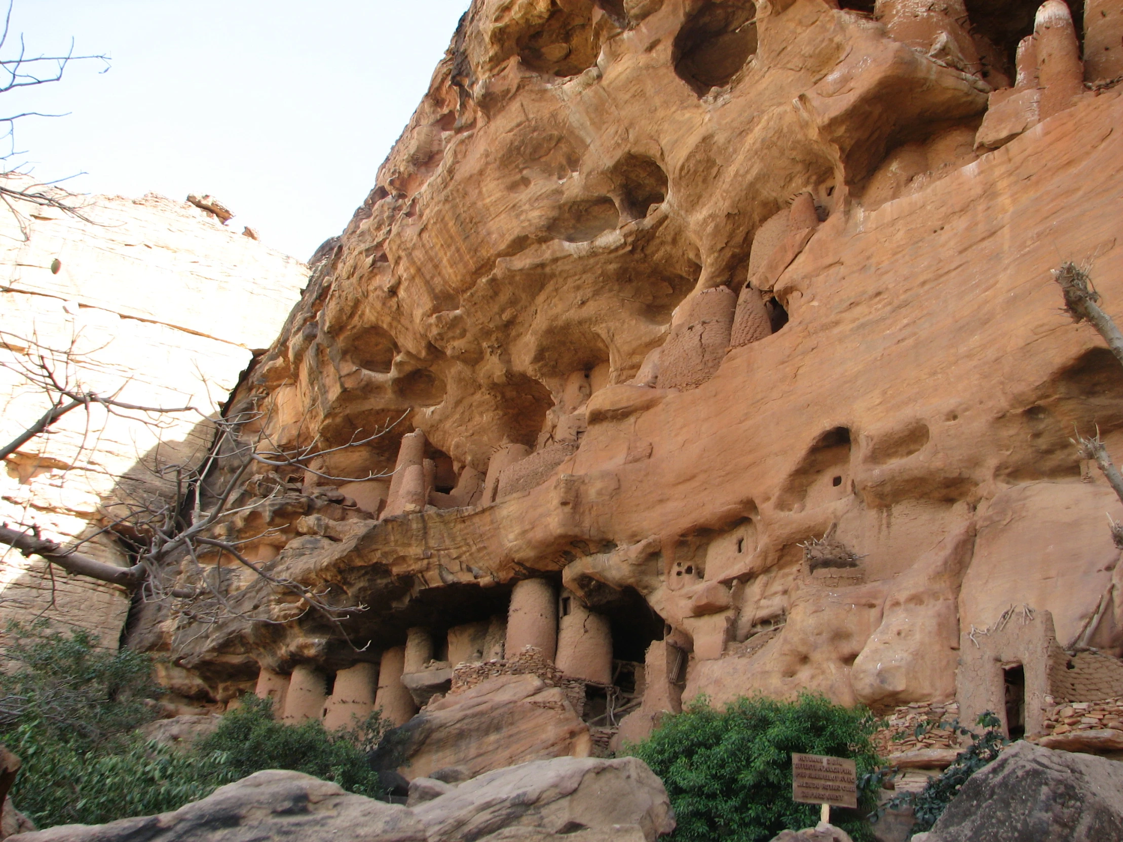 an ancient style building built into the side of a cliff