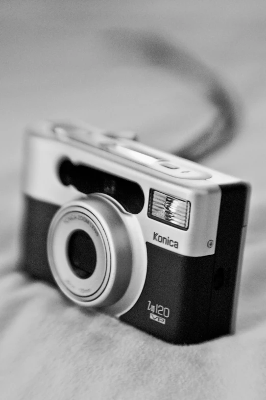 a small digital camera on a bed