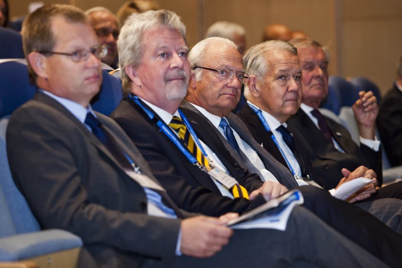 a group of men sitting together at an event