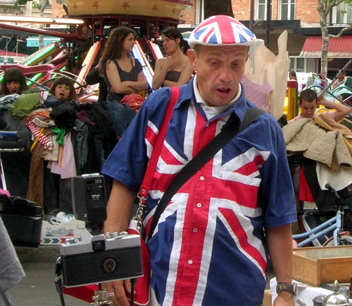 man in an union jack shirt is holding a camera