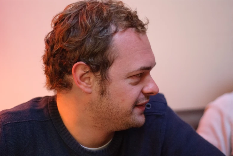 a close up of a person wearing a black sweater