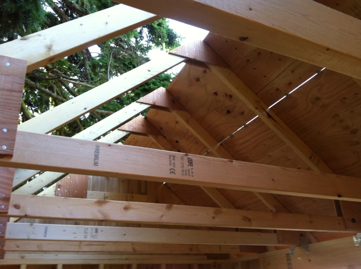 a wooden roof has the rafters exposed and missing