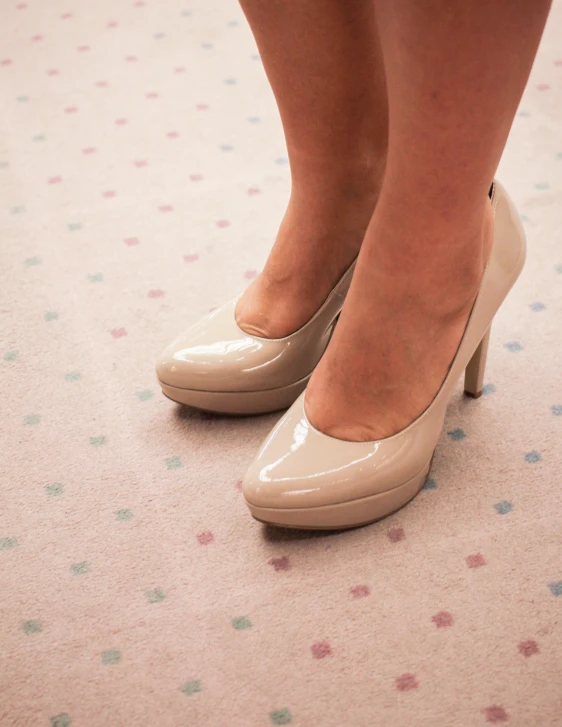 a pair of women's high heel shoes with an ankle tattoo on the toes