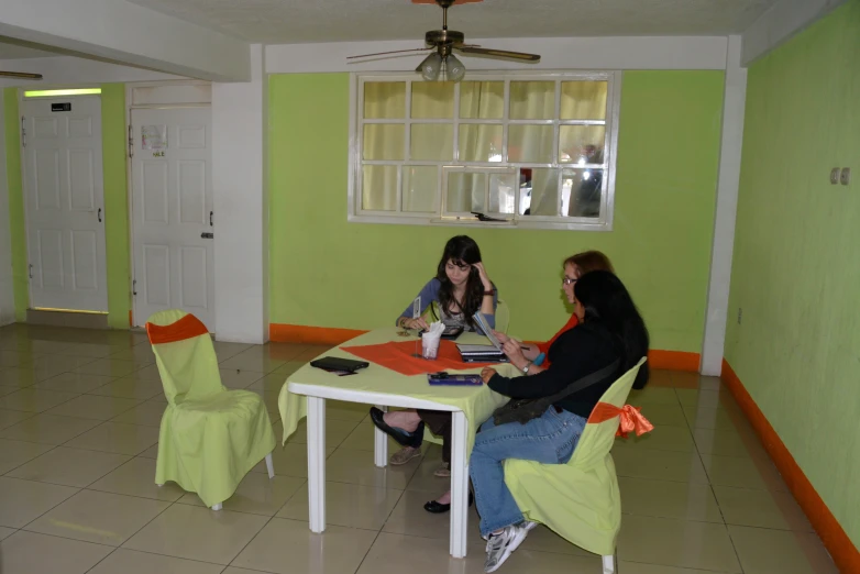 two women sitting at the end of the table