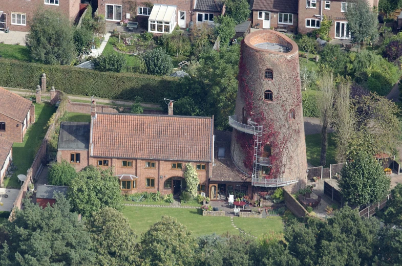 an aerial po of a brick building surrounded by trees