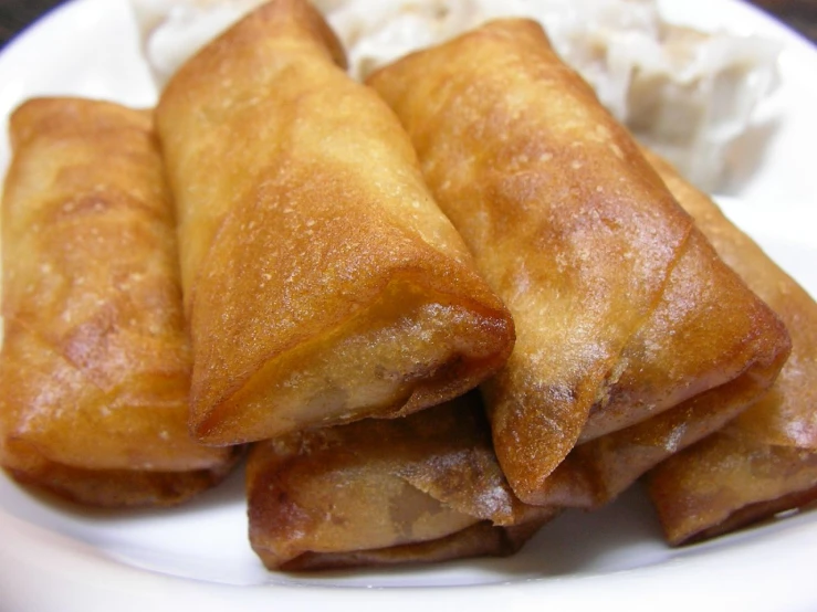 a plate of some kind of pastry with cream on the side