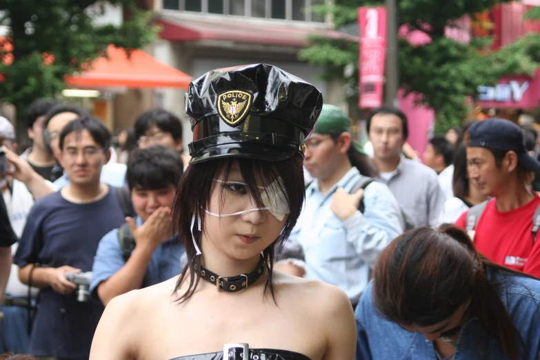 a woman in a black leather outfit wearing a police helmet on her head