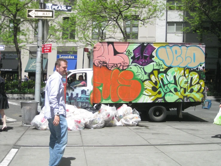 a large truck filled with garbage on top of a street