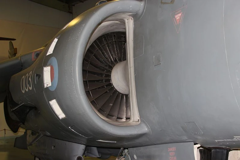 a plane being worked on by someone with a machine