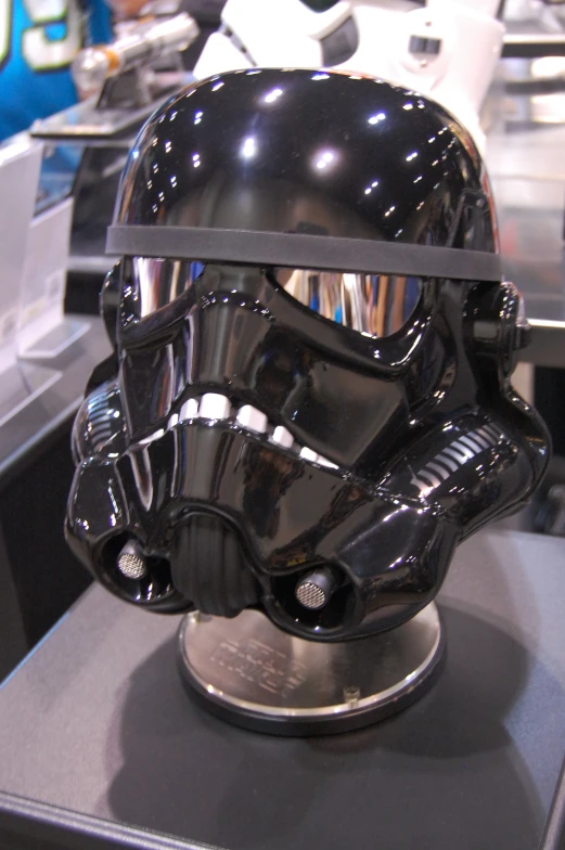 a star wars helmet is sitting on top of a stand