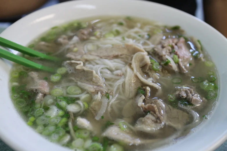 an asian soup filled with noodles and meat