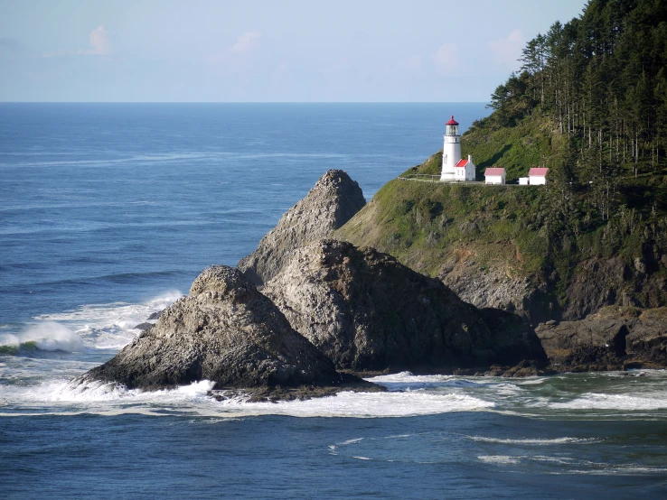 a light house sitting on top of a cliff next to the ocean