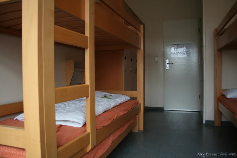 a bedroom with two bunk beds and a door