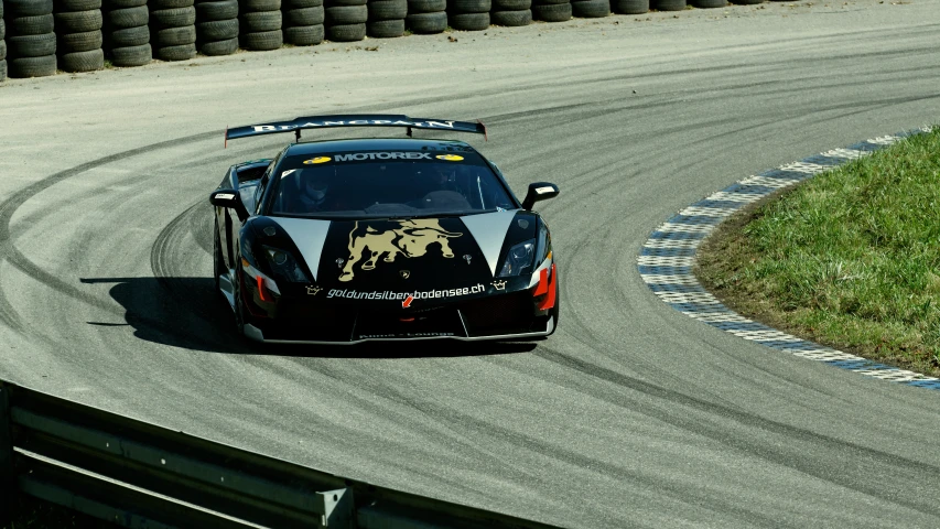 a racing car speeds around a racetrack track