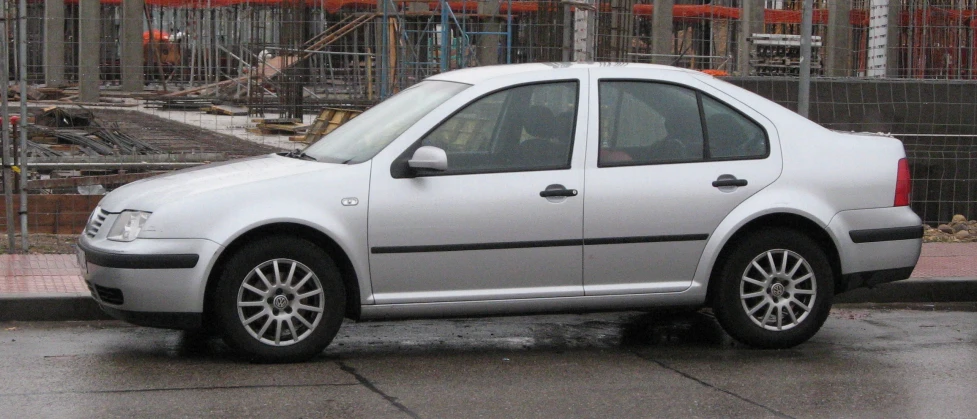 the silver car has many tires on it