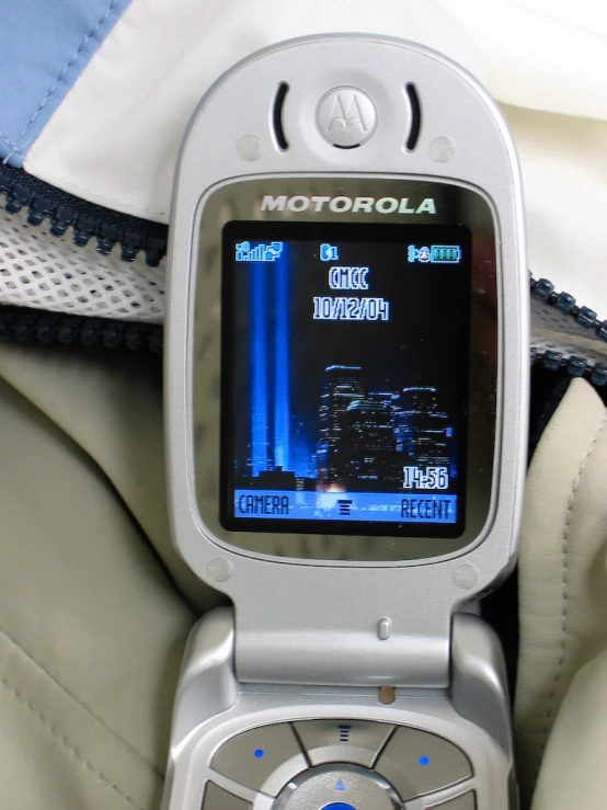 a motorola cell phone held open by someone's lap