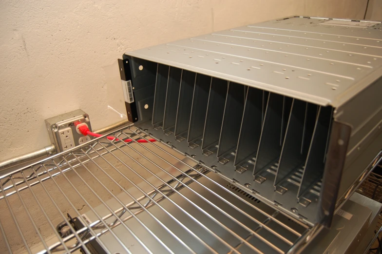 a metal oven that has been placed on top of a shelf